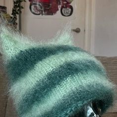 a knitted hat sitting on top of a mannequin head