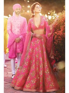 A perfect definition of superb craftsmanship in this beautiful pink colored designer designer sabyasachi bridal lehenga choli. Beautified with amazing heavy embroidery with zari,dori & sequence work within the attire adds a sign of elegance statement with your look. The semi-stitched lehenga is made of Thai Silk fabric accompanied with unstitched embroidered matching fabric blouse piece and embroidered Thai Silk dupatta. Suitable to wear for wedding functions, engagement ceremony and sp Lehenga Sarees, Chaniya Choli For Navratri, Choli For Navratri, Sabyasachi Lehenga Bridal, Lehenga Online Shopping, Orang India, Women Template, Sabyasachi Bridal, Engagement Lehenga