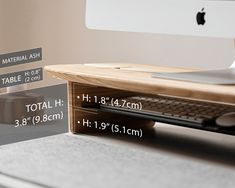 an apple computer sitting on top of a wooden desk