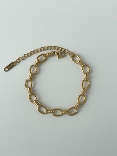 We love this bracelet as a set with our Oval Link Necklace, but this can easily transition into your current everyday stack. This bracelet adds a formal, chic touch to any outfit. 18K gold plating on stainless steel Oversized oval link chain 6.75" chain with 2" extender Water resistant, hypoallergenic Trendy Stainless Steel Chain Bracelet With Gold Chain, Trendy Stainless Steel Gold Chain Bracelet, Gold Stainless Steel Oval Link Bracelets, Elegant Stainless Steel Bracelet With Chunky Chain, Chunky Chain Oval Link Bracelet, Minimalist Metal Chain Bracelet With Oval Links, Metal Charm Bracelet With Tarnish-resistant Rectangular Links, Chic Gold Chain Paperclip Bracelet With Oval Links, Oval Link Gold Bracelet For Everyday