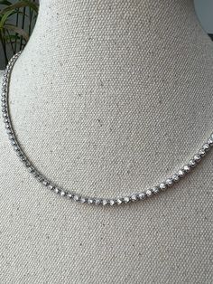 "Adorn yourself with this beautiful bezel round created diamond necklace. Set in sterling silver or gold tone, this necklace features a glamorous 3mm or 4mm 12.98/22.25 TCW diamond set in bezel settings. This sophisticated necklace adds an elegant finishing touch to every outfit. This exquisite necklace is available in three different color tones (silver, yellow gold tone, rose gold tone - please select). Please select the length and color tones above. You will receive ONE necklace with every or Diamond Necklace Set, Color Tones, Tennis Necklace, Diamond Set, Colour Tone, Necklace Set, Silver Gold, Diamond Necklace, Tennis