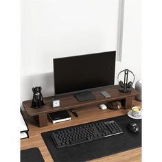 a computer desk with a monitor, keyboard and mouse