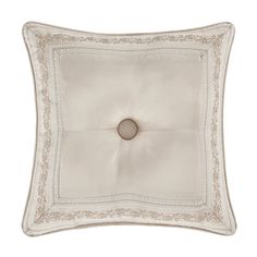 an embroidered square pillow with a button on the center and white trimming around it