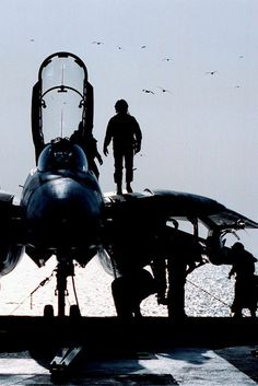 a fighter jet sitting on top of an aircraft carrier