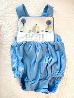 This baby boy summer bubble is perfect for a fun beach trip! This personalized monogram baby sunsuit is perfect for a beach vacation or weekend at the lake! The colors can be customized to your liking. Personalized with name and sailboat trio embroidered. Include in note to seller: Name written out. Shown on baby blue sunsuit in 1st listing pic. Unisex tShirts are also available. Bsby bubbles are sold in sizes 3m-3T. Colors available are white, baby blue, and red. Tshirts are a premium quality6. Playful Cotton Bubble Romper For Vacation, Summer Cotton Tops For Boating, Embroidered Summer Tops For Playtime, Casual Blue Bubble Romper For Summer, Blue Summer Bubble Romper For Beach, Playful Blue Bubble Romper For Summer, Playful Short Sleeve Bubble Romper For The Beach, Playful Short Sleeve Bubble Romper For Beach, Blue Summer Bubble Romper For The Beach