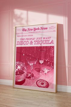 an advertisement for disco and tequila is displayed in front of a pink wall with two wine glasses on it