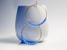 Blue Hoop earrings These classic large gold hoops earrings are lightweight for everyday wear. 14k gold filled big & bold hoops. Simple and thin 14k gold filled wire hoops. These hoops are 2 inches in length and width Made with Blue mini Crystals and wire Gold fill. All of my work is handmade in my studio, each piece is a unique design and one of a kind gift. If you wish to make a gift, select the option and the gift option and it will be sent to you in a white cardboard gift box with a ribbon. Y Blue Hoop Earrings, For Mom, Hoop Earrings Large, Dainty Hoop Earrings, Gold Filled Hoops, Hoop Earrings Gold, Crystal Hoop Earrings, Earrings Christmas, Earrings Large