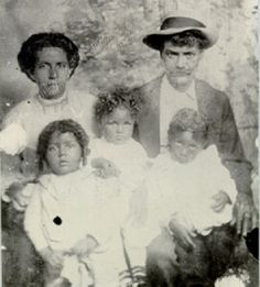 an old black and white photo of a family