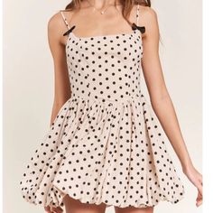 Get Ready To Turn Heads In The Nicolette Polka Dot Mini Dress! This Dress Features A Flattering Square Neckline And A Playful Bubble Hem. The Back Zip Closure Ensures A Secure Fit, While The Bow Detail On The Straps Adds A Charming Touch. With Adjustable Straps And All Over Polka Dot Detailing, This Dress Is Both Versatile And Stylish. Chic Polka Dot Mini Dress For Summer, Polka Dot Mini Dress For The Beach, Polka Dot Mini Sundress For Summer, Polka Dot A-line Mini Dress For Summer, Fitted Polka Dot Sundress For Summer, Polka Dot Mini Dress For Summer, Flirty Polka Dot Mini Dress For Summer, Flirty Polka Dot Mini Dress For Spring, Polka Dot Summer Mini Dress