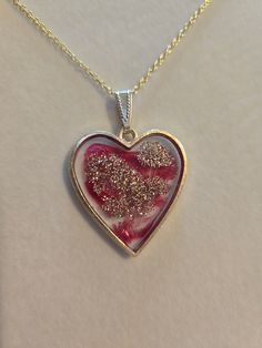 Pretty, heart shaped resin, pendant necklace with red and gold shimmer highlights set in a lead and nickel free bezel. You can choose between an 18" or 20" gold plated steel/iron chain.  Dimensions are approximate  Please message me here or email me at megrencreations@gmail.com if you have special requests, i.e.  if there is a piece you like - but maybe a different color, multiple pieces for a wedding, etc. Pretty Heart, Resin Pendant Necklace, Heart Shaped Pendant Necklace, Heart Shaped Pendant, Heart Shape Pendant, Mom Daughter, Gold Shimmer, Handmade Gold, Resin Pendant