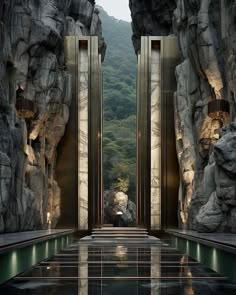 two doors are open in front of some rocks and water at the entrance to a cave