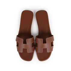 This pair of Oran Sandals are in Gold calfskin leather with contrast stitching, a natural leather insole and feature the iconic H crossover strap. Origin: ItalyCondition: New and never wornAccompanied by: Hermes box, dustbags, carebook and ribbonSize: 37.5 EU Sandals With Small Heel, Classic Tan Sandals With Leather Sole, Classic Tan Sandals With Leather Lining, Classic Tan Leather Sandals, Brown Open Heel Calf Leather Mules, Classic Brown Calf Leather Mules, Brown Calf Leather Mules With Removable Insole, Brown Closed Toe Calf Leather Sandals, Designer Brown Mules With Leather Lining