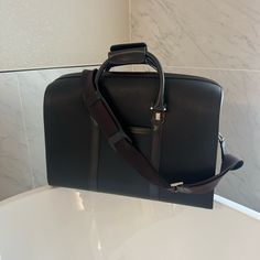 Dunhill Black Leather Duffle Bag, Like New. Never Used Black Bags With Detachable Handle For Business Trips, Black Bag With Detachable Handle For Business Trips, Black Bags For Business Trips With Detachable Handle, Black Satchel With Detachable Handle For Business Trips, Luxury Black Satchel For Business Trips, Elegant Formal Travel Bag With Detachable Strap, Luxury Brown Duffle Bag For Formal Occasions, Elegant Black Duffle Bag With Detachable Handle, Brown Luxury Duffle Bag For Formal Occasions