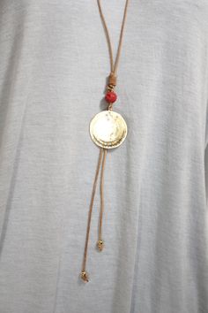 This adjustable long necklace features an 40mm in diameter Our Father or Padre Nuestro pendant. The prayer is engraved in Spanish. The leather used is natural colored and finished Greek leather. The Pendant is accented with a mother of pearl cross and etched cinnabar red bead. The pendant is on a sliding knot so the final length of the necklaced can be adjusted. This necklace is great for all seasons and its mixed tones makes it a very versatile piece. Adjustable Brass Medallion Necklace, Adjustable Round Necklaces For Everyday Use, Adjustable Medallion Necklace, Brown Spiritual Necklaces With Adjustable Length, Brown Spiritual Necklace With Adjustable Length, Brown Necklace With Adjustable Cord And Round Pendant, Adjustable Medallion Necklace With Large Pendant, Adjustable Brown Medallion Necklace, Adjustable Long Bronze Necklace