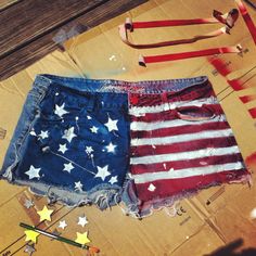 an american flag and two pairs of denim shorts