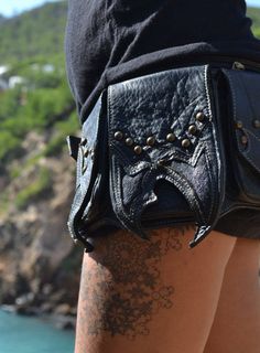 "Leather steampunk waist bag -black cow leather and sting ray waist bag three front side pocket with button: 2pocket 3inch x 5inch - 1pocket 4inch x 6inch one big front zip : 12inch x 5.5 one rear side secret pocket : 9 inch x 5.5 (mini tablet) -Sizes: size S: [31\" to 36\"] or [79 cm to 92 cm] size M: [33\" to 38\"] or [84 cm to 97 cm] size L: [36\" to 42\"] or [92 cm to 106 cm] size XL: [40\" to 46\"] or [101 cm to 116 cm] XXL and any other size made it to order Check all our Hip Belt on LEATH Leather Bags With Rivets For Alternative Fashion, Black Belt Bag With Adjustable Strap For Festivals, Steampunk Leather Bag With Belt Loops, Punk Leather Bag For Festivals, Black Belted Bag For Festival, Black Shoulder Bag With Cell Phone Pocket For Festivals, Leather Festival Bag With Belt Included, Black Belt Bag With Pockets For Festival, Festival Leather Bag With Belt Included