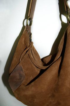 Handmade brown cognac suede medium size hobo bag The bag is closed with a metallic zip. Inside is unlined and there is a large cotton zipped pocket. The bag has an adjustable shoulder strap made with strong black leather. To add an extra touch to the bag you can buy the short handle which measures 18 inch in length and is made with beautiful black leather. This medium size hobo bag is a perfect bag for every moment Features : - Brown cognac suede, - Brown cognac leather strap, - Zipped bag, - Un Suede Hobo Shoulder Bag With Zipper, Suede Hobo Shoulder Bag With Zipper Closure, Suede Hobo Bag With Zipper Closure, Suede Hobo Bag With Zipper For Everyday Use, Suede Hobo Bag With Zipper For Daily Use, Suede Hobo Bag With Zipper Closure For Daily Use, Everyday Suede Hobo Bag With Zipper Closure, Chic Brown Suede Hobo Bag, Chic Brown Hobo Bag With Zipper Pocket