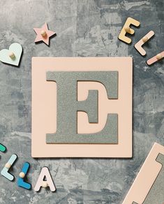 the letter e is surrounded by wooden letters