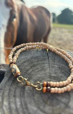 This lovely bracelet is a double string beaded bracelet with an oxidized brass lobster clasp.  The neutral tan beads with the accent of small wooden beads highlight the large beautiful bead.  This bracelet will go with just about any outfit. Oxidized Brass, Strung Beads, Boho Bracelet, Boho Bracelets, Wooden Beads, Last Minute Gifts, Arm Band, Beaded Bracelet, Favorite Jewelry