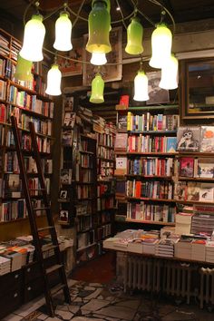 a room filled with lots of books and lights