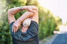 an older man stretching his arms and shoulders