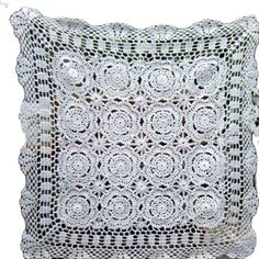 a white crocheted pillow on a white background