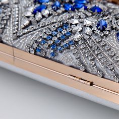 Add a touch of elegance to your evening party look with our exquisite Bridal Clutch Elegant Leaf Locker. This stunning clutch features a unique new design with intricate leaf patterns in a beautiful shade of blue, making it the perfect accessory for any bridal or special occasion outfit. Embellished Clutch For Wedding Guests, Blue Rhinestone Evening Bag For Weddings, Blue Rhinestone Evening Bag For Party, Blue Embellished Evening Bag For Formal Occasions, Blue Rhinestone Evening Bag, Silver Festive Party Clutch, Festive Silver Party Clutch, Formal Blue Embellished Evening Bag, Elegant Blue Evening Bag With Rhinestones