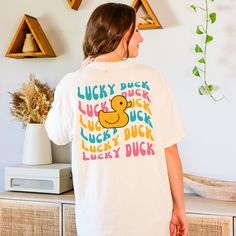 Get ready to be OBSESSED with your new Lucky Duck shirt. It's the cutest and most trendy way to emit all those positive vibes! This is the perfect silly tshirt! Great as a gift! * Q U I C K * F A C T S * ✺ 100% preshrunk cotton ✺ Wash and dry normally inside out (on cool for best results) * S I Z I N G * ✺Comfort Colors C1717 ✺ Sizing is unisex so runs like men's, though not overly large ✺ Most women find their typical size works best, since they are meant to fit a touch loose ✺ See size guide in photos for more info * S H I P P I N G * T I M E S * ✺ Our items are individually made with love for each of our buyers. Because of this, our processing time is 2-5 business days (depending on order volume) plus transit time, but typically much faster. We know our customers want their items as qui Cute White T-shirt With Letter Print, Cute Cotton T-shirt With Funny Print, Trendy Crew Neck Shirt With White Print, Trendy White Print Crew Neck Shirt, Fun Cotton T-shirt With Funny Print, Fun White Print Crew Neck Tops, Trendy Crew Neck Shirt With Funny Print, Funny Text White Cotton Tops, Playful White T-shirt With Funny Text