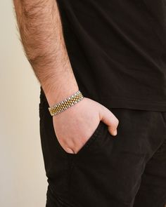 This sleek and sophisticated watch band chain bracelet is the perfect statement piece for any gentleman. Elevate your style with this luxurious men's jewelry that combines fashion and function. Make a bold statement with this exclusive accessory. Materials: 14K gold plated stainless steel, rhodium plated stainless steel Features: Measures 7" length, 0.6" width, Lead & Nickel free, foldover single channel clasp Gold Stainless Steel Jubilee Chain Link Bracelet, Stainless Steel Gold Jubilee Chain Link Bracelet, Formal Cuban Link Metal Bracelets, Formal Cuban Link Metal Bracelet, Formal Stainless Steel Box Chain Bracelet, Elegant Metal Jubilee Bracelet Watch Bands, Modern Gold Watch Band With Stainless Steel Clasp, Adjustable Stainless Steel Gold Bracelet With Box Chain, Adjustable Gold Bracelet With Box Chain In Stainless Steel