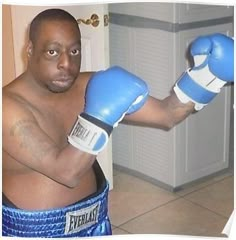 a man wearing blue boxing gloves is posing for the camera