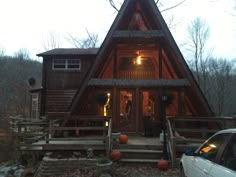 a large wooden cabin with stairs leading up to it