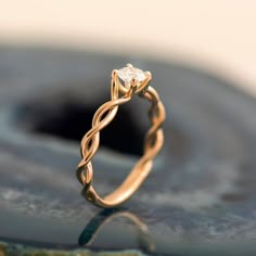 a gold ring with a diamond in the middle