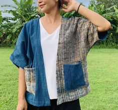 This Indigo dye Jacket is made entirely by myself from growing the cotton and indigo to making the pattern and stitching.   I live in the Sakon Nakon province in the North East of Thailand and been selling my products locally for most of my life until I found Etsy to sell worldwide. Please check out my bio to see videos and pictures of how indigo cotton is made. The item is free size so will fit most sizes, measurements are as follows Length 24" Arm Pit to Arm Pit on the back is 26" Sleeve Length is 16" Please allow up to 3-4 working days for item to be sent which will give me enough time to complete the item. If you have any questions about the item please do ask and I will do my best to answer your questions. Cotton Kimono With Natural Dye And Kimono Sleeves, Cotton Kimono With Natural Dye And Relaxed Fit, Casual Cotton Kimono With Natural Dye, Indigo Cotton Outerwear With Natural Dye, Bohemian Cotton Outerwear In Indigo, Bohemian Indigo Cotton Outerwear, Kimono Shirt, Poncho Coat, Indigo Dye