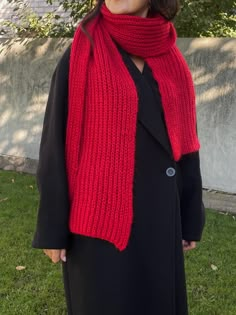 a woman wearing a red knitted scarf