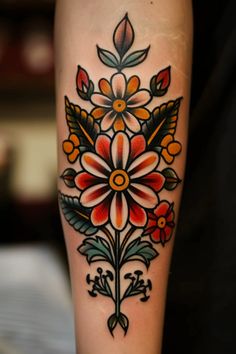 a colorful flower tattoo on the leg