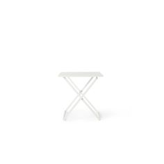 a small white table sitting on top of a white floor