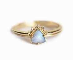 a gold ring with a blue stone in the middle and a star on it's side