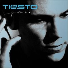 a man talking on a cell phone while holding his hand up to his ear with the word tiesto written across it