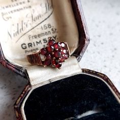 This elegant antique style gold and garnet ring would make a wonderful gift for that special someone. Set in 9 ct solid rosey yellow gold featuring 13 deep red natural garnets in a flower design. Fully British Hallmarked. INTERNATIONAL BUYERS - please read the shipping information below. Follow us on Instagram for all our latest pieces and first Dibs! They don't all make it to our Etsy store: https://www.instagram.com/mooreperfectpieces/ Fully British Hallmarked - 375 hallmark,  denoting solid 9 Vintage Garnet Birthstone Ring In Yellow Gold, Vintage Yellow Gold Garnet Birthstone Ring, Vintage Garnet Birthstone Promise Ring, Antique Garnet Promise Ring, Vintage Gold Garnet Birthstone Ring, Vintage Garnet Birthstone Rings, Vintage Garnet Promise Ring, Vintage Garnet Cluster Ring As Gift, Vintage Garnet Birthstone Ring For Anniversary