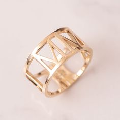 a gold ring on a white surface