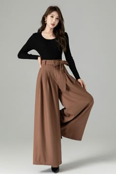 "These pants seamlessly blend style and comfort. The wide-leg silhouette offers a flattering and timeless fit, while the high-quality fabric ensures warmth and softness. These versatile brown wool wide-leg pants can be dressed up with a blouse and heels for a polished office look or paired with a cozy sweater and boots for a chic and comfortable ensemble. Embrace the elegance and coziness of our brown wool wide-leg pants. DETAIL * 30% wool, 30% fiber, 40% polyester * polyester lining * Seam pocket * Front zipper and buttons closure * Skirt pants, wide leg pants, Pleated pants * Perfect forSpring, autumn, and winter * Wash by hand or machine with cold water *The model is 170 cm (5′7″) tall with a 80 cm (31.5\") bust, 66 cm (26\") waist. She is wearing the pants in size XS. CUSTOM MADE SERVI Bodysuit Wide Leg Pants, Pants For Autumn, Long Sleeve Pants Outfit, Palazzo Pant Outfit, Brown Pleated Pants Outfit, Winter Outfits With Pants, Feminine Pants Outfit, Wide Leg Brown Pants Outfit, Loose Pants Outfit Classy