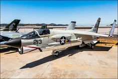 two fighter jets sitting on top of an airport tarmac