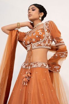 Ochre brown lehenga, accentuated with floral embroidery in cutdana and sequin embellishments. Paired with a half sleeve, sweetheart neckline blouse, highlighted with pearl, cutdana and sequin embellishments in floral pattern. Comes with a floral embroidered border dupatta.
Component: 3
Pattern: Embroidery,Embellished
Type Of Work: Floral,Pearl,Sequin,Cutdana
Neckline: Sweetheart Neck
Sleeve Type: Half Sleeves
Fabric: Silk, Organza
Color: Brown
Other Details: 
Floral embroidered waistband
Fabric Brown Lehenga, Sweetheart Neckline Blouse, Embroidered Border, Embroidery Floral, Pattern Embroidery, Brown Silk, Silk Embroidery, Silk Organza, Fabric Silk