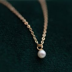 This Mini Pearl Pendant Necklace is the perfect complement for your evening wear or casual wardrobe. Crafted from 14k gold, this delicate necklace features a small cultured pearl, lending it a minimalist and elegant look. With this classic and versatile accessory, you're sure to make a statement. Pearl size: 2.75-3mm 1 Classic Pearl Necklace With Delicate Chain, Classic 14k Gold Pearl Necklace With Round Pendant, Minimalist Pearl Necklace With Round Pendant, Classic Pearl Necklace With Round Pendant And Delicate Chain, Dainty Rose Gold Pearl Necklace For Formal Occasions, Classic 14k Gold Necklace With Pearl Charm, Elegant Rose Gold Pearl Necklace With Delicate Chain, Classic Formal Necklace With Simple Design, Formal 14k Gold Pearl Necklace With Delicate Chain