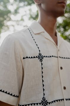 Sunlit squaresthe squares, a window to the afternoon sun, casting beautiful gentle patterns on this breathable cotton shirt Detail: Suf embroidery in beautiful squares throughout the shirt Color: Natural white kala cotton Fabric: Hand woven 1 by 1 kala cotton Fit: Leisure Fit Care Instructions: Hand wash and cool rinse. Drip dry in shade and steam/iron on the reverse side to preserve the fabric’s natural texture and sheen Model Information: Gopi is 5'10 and he is wearing a size Medium shirt Wear White Cotton Kurta With Geometric Embroidery, Traditional Embroidered Linen Shirt, White Summer Shirt With Chikankari Embroidery, Casual Cotton Shirt With Geometric Embroidery, White Cotton Shirt With Chikankari Embroidery, Traditional Linen Tops With Chikankari Embroidery, White Cotton Chikankari Embroidered Shirt, Casual Cotton Shirt With Chikankari Embroidery, Traditional Cotton Shirt With Chikankari Embroidery