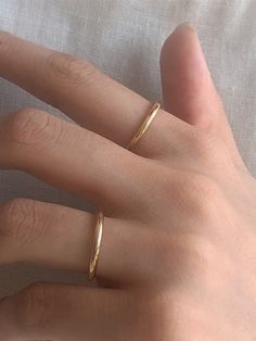 Editor's Notesbyweekend presents an essential round ring with a glossy surface. It is a simple yet, feminine item that stands out. - Plain round ring- Plain glossy surface- Made of silver 925- 18K gold plated- Sleek silhouette- Simple and basic style Measurements(in.)- Size: 3 / 5 / 7 / 9 / 11 / 13 / 15 / 17 / 19 Composition & Care- Material: Silver 925, 18K Gold Plating- Plated products may discolor over time due to their nature.- Please be careful that discoloratio Basic Rings Simple, Classic Adjustable Midi Rings, Minimalist Adjustable Round Band Rings, Adjustable Minimalist Round Band Rings, Simple Open Band Rings For Everyday, Classic Adjustable Couple Rings For Everyday Wear, Simple Design Round Midi Rings For Anniversary, Simple Round Midi Rings For Anniversary, Simple Design Midi Rings For Anniversary