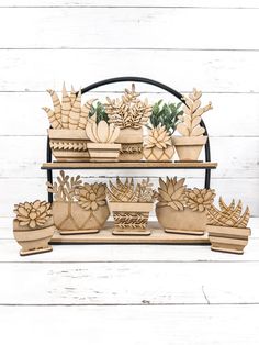 three tiered wooden plant stand with potted plants