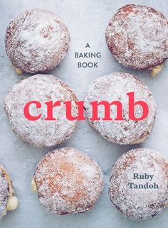 the cover of crumb by ruby tanlon, with six powdered sugar covered donuts