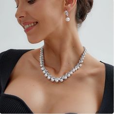 Pearl and CZ Wedding Jewelry Set Complete your elegant wedding day look with our fabulous pearl and CZ necklace and earring set. This glamorous platinum silver plated jewelry set features dazzling AAAAA quality CZ crystals in round and teardrop cuts as well as lustrous pearl beads. This luxurious jewelry set will add timeless elegance to any bridal ensemble. Size: The necklace is about 17" long and the pierced earrings are about 1" long. Color: Silver. Style: ne10130. Please allow about 3 weeks for delivery. Shipping Policy . Return Policy Silver Pearl Bridal Sets For Formal Occasions, Formal Silver Pearl Bridal Sets, Elegant Pearl Bridal Sets With Pearl Drop, Formal Pearl Drop Jewelry Sets With Cubic Zirconia, Anniversary Jewelry Sets With Pearl Drop And Cubic Zirconia, Elegant Pearl Bridal Sets For Formal Occasion, Silver Bridal Necklace With Pearl Drop And Cubic Zirconia, Silver Cubic Zirconia Pearl Necklace For Wedding, White Gold Pearl Necklace With Cubic Zirconia For Wedding