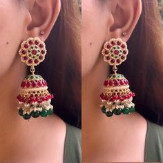 Introducing the most gorgeous and elegant pair of Kundan Jhumka earrings! These earrings are high quality and will adorn your outfit with a look of royalty and elegance. With Pink and Green as the primary colours, these earrings are perfect to make you look class apart. They are light in weight while also being big in size. These earrings are truly a statement piece so grab yours now!  Please feel free to contact us in case of any queries. Happy shopping! Luxury Green Jhumkas For Diwali, Wedding Jhumkas With Latkans, Wedding Drop Jhumkas With Latkans, Wedding Drop Jhumkas, Wedding Tilla Drop Jhumkas, Elegant Bridal Earrings For Wedding And Navratri, Elegant Earrings For Wedding And Navratri, Wedding Chandbalis For Navratri, Drop Earrings Style, Elegant Wedding Earrings For Navratri